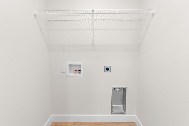 335 Mccann Rd, Powersite, MO 65731 - laundry area featuring hookup for an electric dryer, baseboards, washer hookup, and wood finished floors