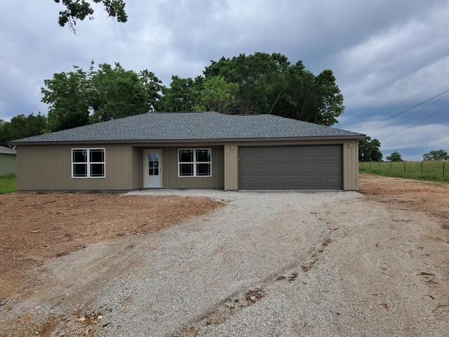 335 Mccann Rd, Powersite, MO 65731 - ranch-style house with dirt driveway and an attached garage