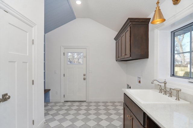 clothes washing area with hookup for a washing machine, cabinet space, light floors, and healthy amount of natural light
