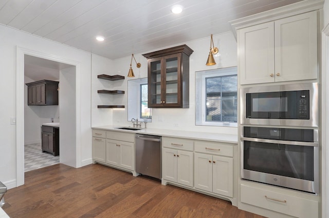 kitchen featuring stainless steel appliances, open shelves, light countertops, a sink, and recessed lighting