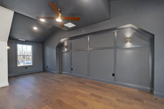 bonus room featuring wood finished floors, ceiling fan, baseboards, and vaulted ceiling