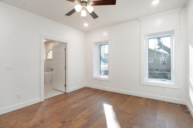 spare room featuring a ceiling fan, baseboards, wood finished floors, and recessed lighting