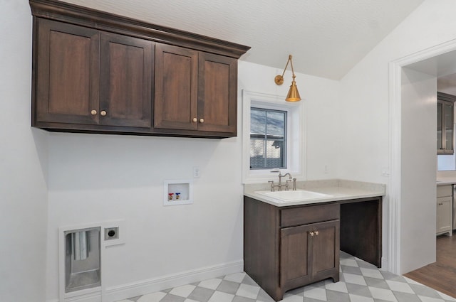 laundry area featuring cabinet space, hookup for an electric dryer, light floors, hookup for a washing machine, and baseboards
