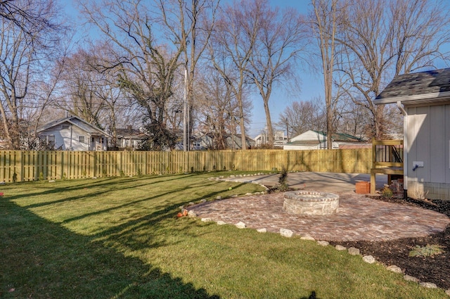 view of yard featuring a patio, an outdoor fire pit, and a residential view