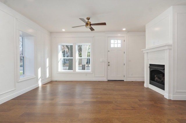 unfurnished living room with ceiling fan, wood finished floors, a glass covered fireplace, and recessed lighting