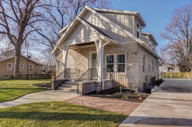 view of front facade with stone siding, board and batten siding, and central AC unit