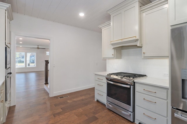 kitchen with stainless steel appliances, dark wood-style floors, light countertops, tasteful backsplash, and recessed lighting