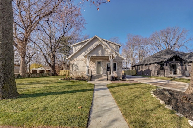 view of front of property featuring a front lawn and stone siding