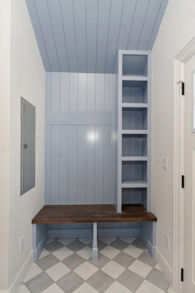 mudroom featuring electric panel, baseboards, and built in shelves
