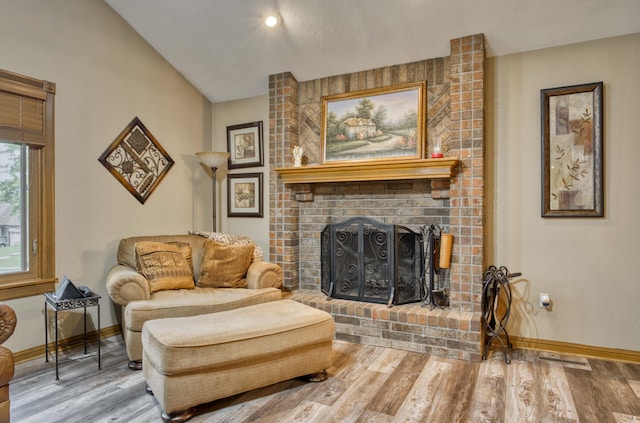 5425 S Westwood Ave, Springfield, MO 65810 - sitting room with a brick fireplace, baseboards, wood finished floors, and lofted ceiling