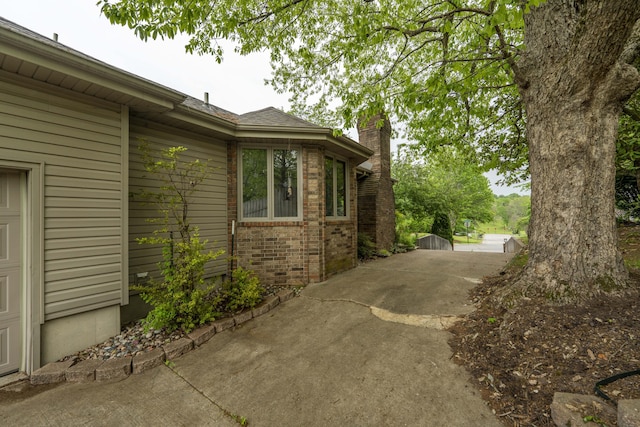 5425 S Westwood Ave, Springfield, MO 65810 - view of side of property with a chimney and brick siding