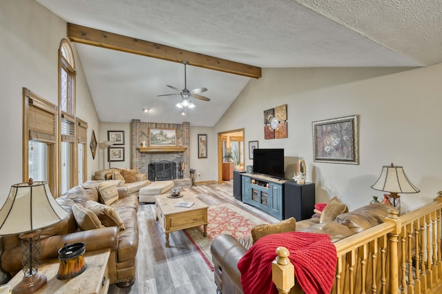 5425 S Westwood Ave, Springfield, MO 65810 - living area with wood finished floors, beamed ceiling, ceiling fan, a fireplace, and high vaulted ceiling