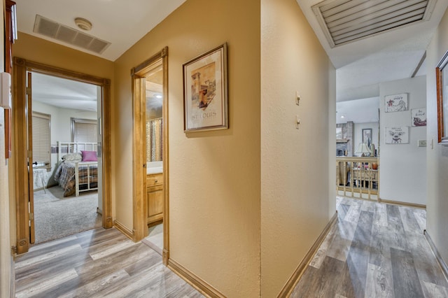 5425 S Westwood Ave, Springfield, MO 65810 - hall featuring light wood-type flooring, baseboards, and a textured wall