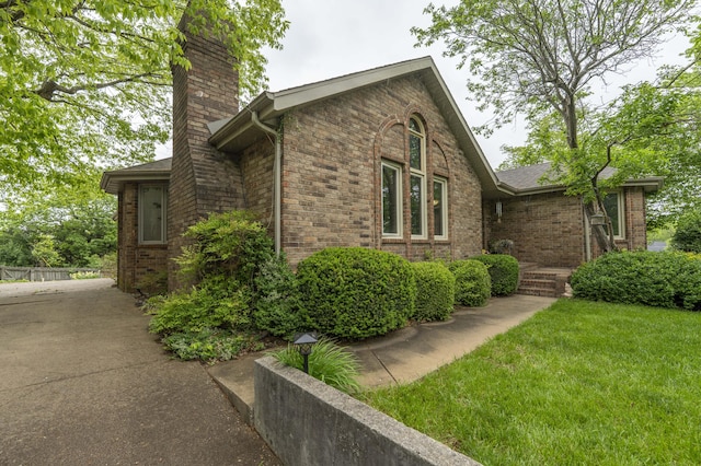 5425 S Westwood Ave, Springfield, MO 65810 - view of home's exterior featuring a chimney and brick siding