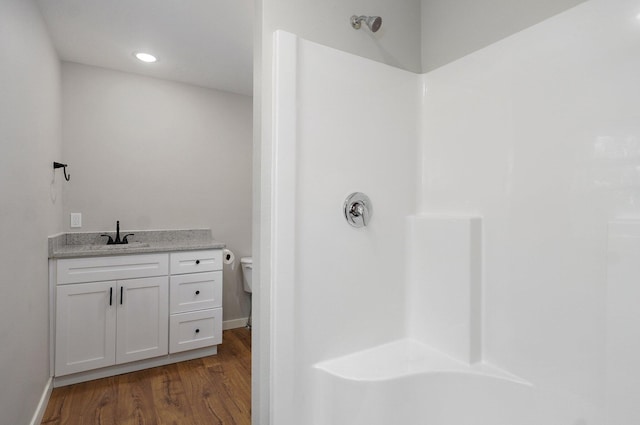 610 Chicago Ave, Marionville, MO 65705 - full bathroom with a shower, wood finished floors, toilet, vanity, and baseboards