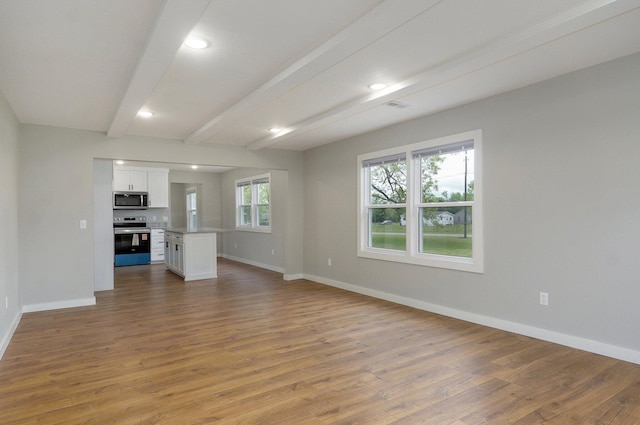 610 Chicago Ave, Marionville, MO 65705 - unfurnished living room with baseboards, wood finished floors, beamed ceiling, and recessed lighting