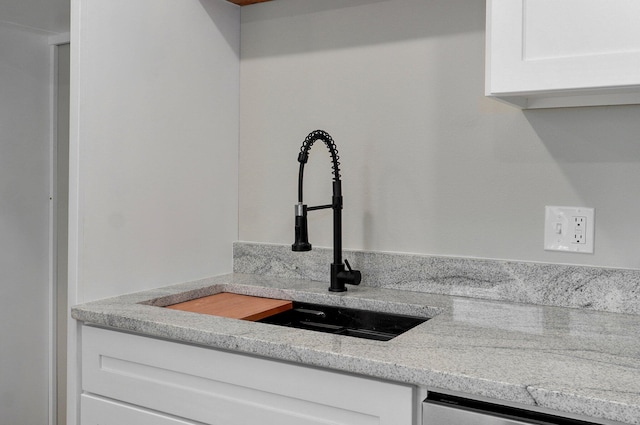 610 Chicago Ave, Marionville, MO 65705 - detailed view of a sink, white cabinetry, light countertops, and dishwasher