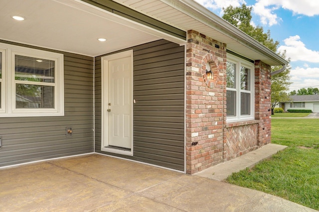 610 Chicago Ave, Marionville, MO 65705 - property entrance featuring brick siding and a lawn