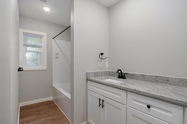 610 Chicago Ave, Marionville, MO 65705 - bathroom featuring vanity, wood finished floors, shower / bath combination, and baseboards