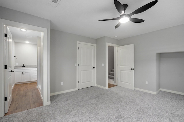 610 Chicago Ave, Marionville, MO 65705 - unfurnished bedroom featuring light carpet, a sink, baseboards, ensuite bath, and a ceiling fan