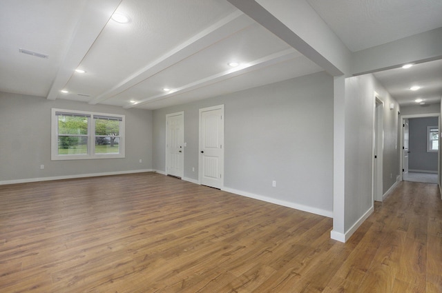 610 Chicago Ave, Marionville, MO 65705 - empty room featuring baseboards, wood finished floors, beam ceiling, plenty of natural light, and recessed lighting