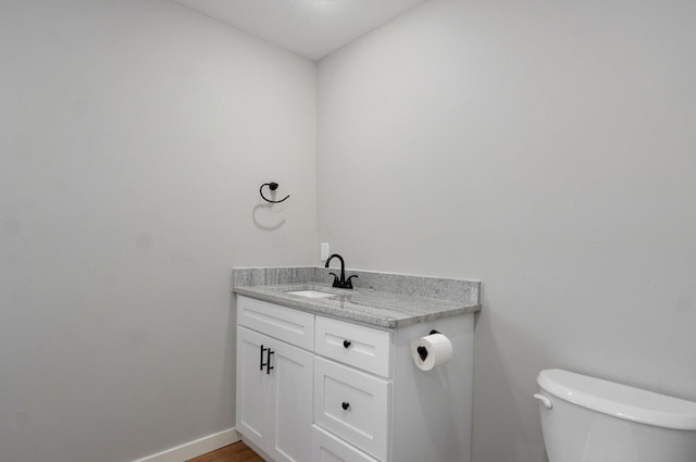 610 Chicago Ave, Marionville, MO 65705 - bathroom with toilet, vanity, and baseboards