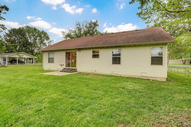 back of property with entry steps and a patio