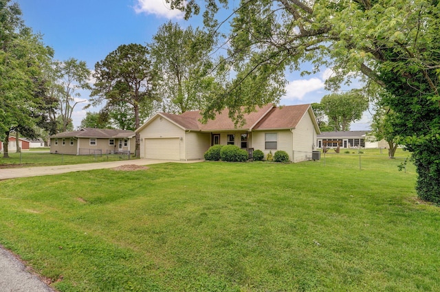 ranch-style house featuring a garage, driveway, and central AC