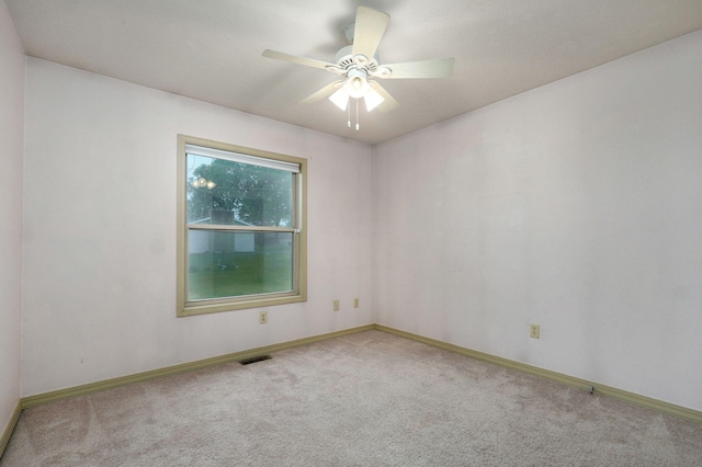 carpeted empty room with baseboards and ceiling fan