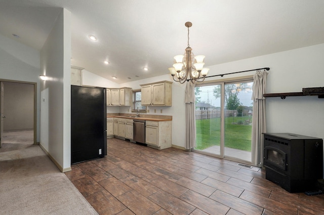 kitchen featuring stainless steel dishwasher, freestanding refrigerator, a chandelier, lofted ceiling, and light countertops