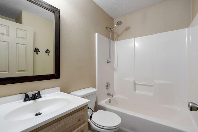 bathroom featuring toilet, vanity, washtub / shower combination, and a textured ceiling