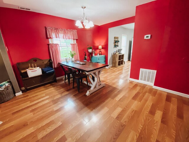 310 W Delta St, Aurora, MO 65605 - dining space with a chandelier, wood finished floors, and baseboards