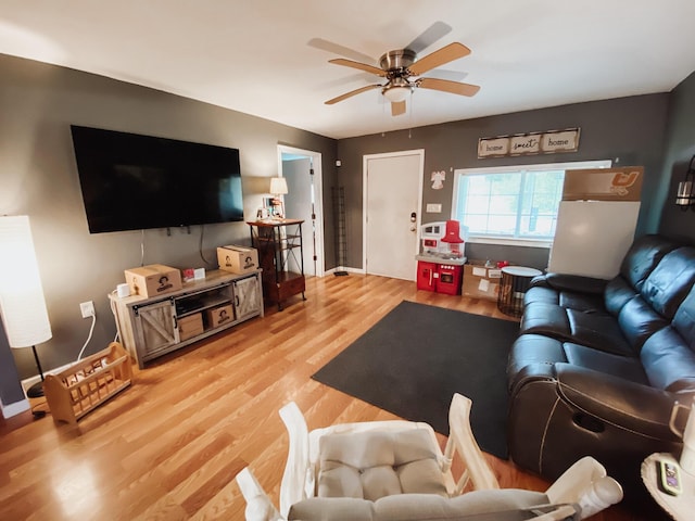 310 W Delta St, Aurora, MO 65605 - living area with wood finished floors, a ceiling fan, and baseboards