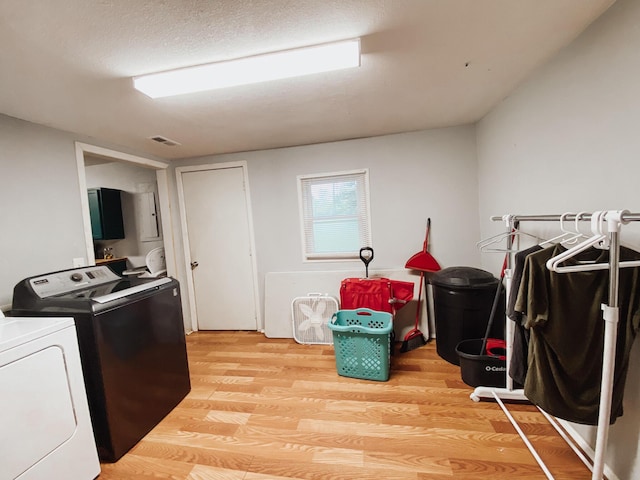 310 W Delta St, Aurora, MO 65605 - washroom with washing machine and clothes dryer and light wood-style flooring