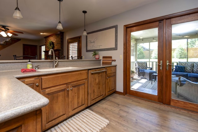 1918 E Buena Vista St, Springfield, MO 65804 - kitchen with a sink, brown cabinets, french doors, and pendant lighting