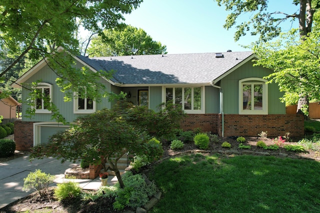 1918 E Buena Vista St, Springfield, MO 65804 - ranch-style house with a shingled roof, brick siding, an attached garage, a front lawn, and concrete driveway