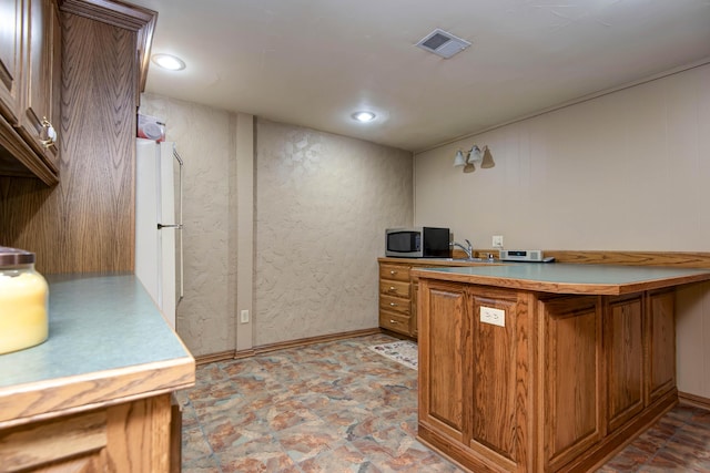 1918 E Buena Vista St, Springfield, MO 65804 - bar area with stainless steel microwave, recessed lighting, and freestanding refrigerator