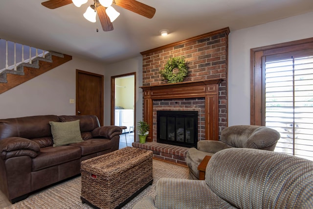 1918 E Buena Vista St, Springfield, MO 65804 - living room with washing machine and dryer, ceiling fan, a brick fireplace, and stairs