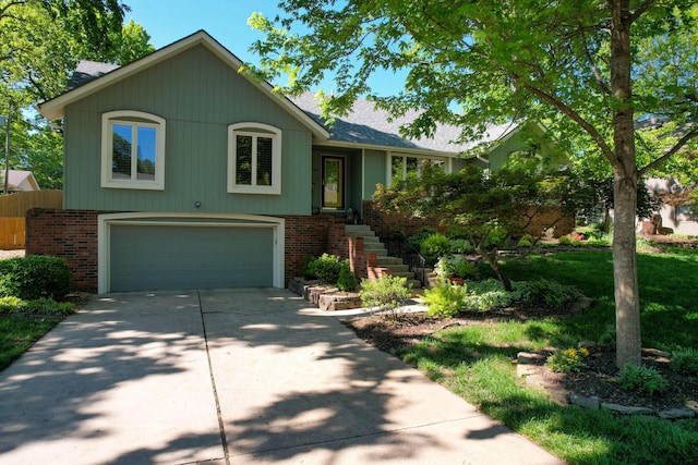 1918 E Buena Vista St, Springfield, MO 65804 - view of front of house with an attached garage, brick siding, driveway, and roof with shingles