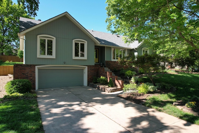 1918 E Buena Vista St, Springfield, MO 65804 - view of front of house featuring a garage, brick siding, driveway, and roof with shingles