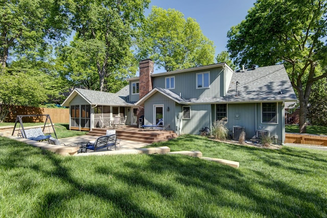1918 E Buena Vista St, Springfield, MO 65804 - rear view of house featuring a chimney, a sunroom, roof with shingles, a deck, and cooling unit