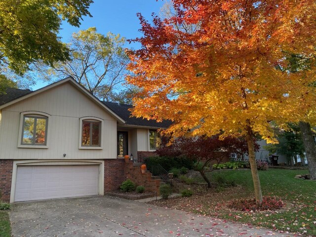 1918 E Buena Vista St, Springfield, MO 65804 - view of front facade featuring brick siding, a garage, and driveway