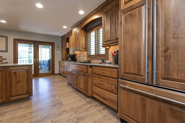 1918 E Buena Vista St, Springfield, MO 65804 - kitchen with recessed lighting, french doors, light wood-style floors, baseboards, and brown cabinetry