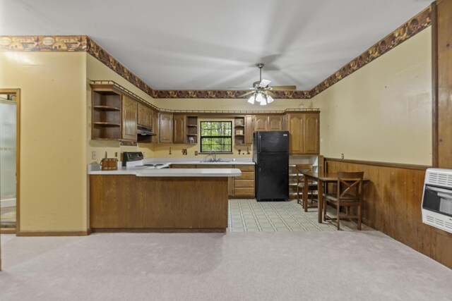 kitchen featuring open shelves, freestanding refrigerator, range, heating unit, and under cabinet range hood