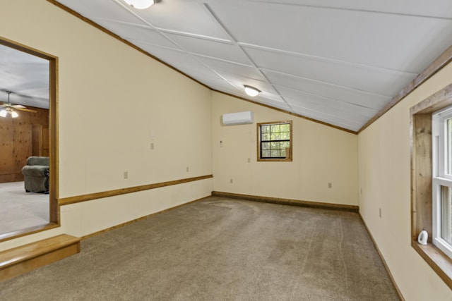 basement featuring carpet, a wall mounted air conditioner, baseboards, and a ceiling fan
