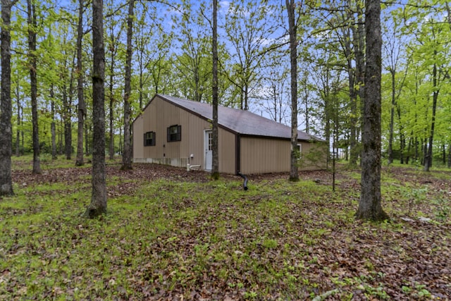view of home's exterior with an outbuilding and an outdoor structure