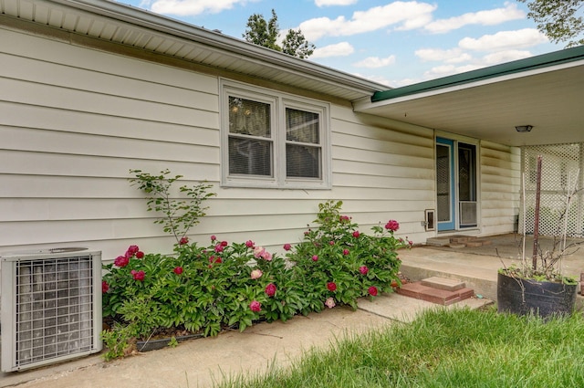 entrance to property featuring cooling unit and a patio area