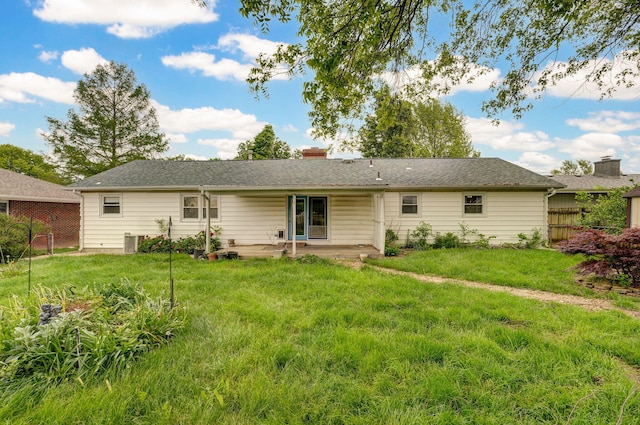 back of property featuring a patio area, a chimney, and central AC unit