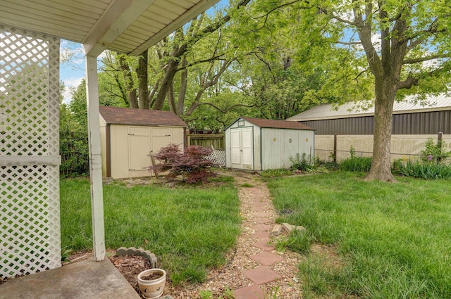 view of yard with a storage shed and an outbuilding