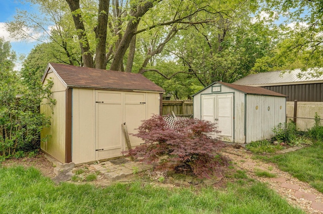view of shed featuring fence